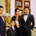 A formally dressed South Asian family gathering, representing the rishta registration process in Pakistan