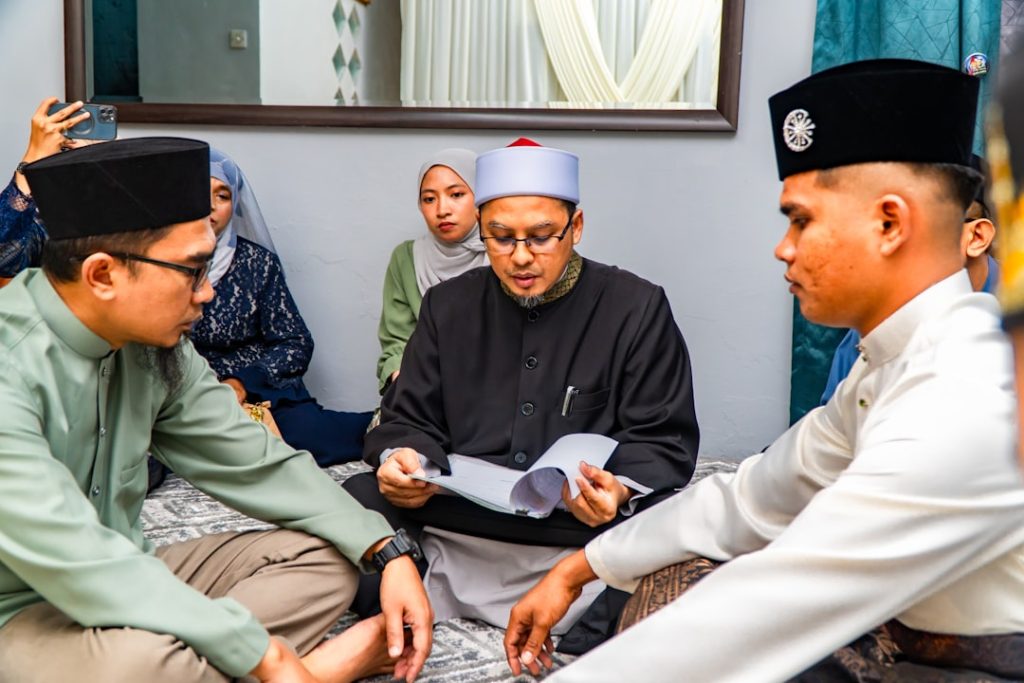 Muslim men and family reviewing a document together during a rishta discussion