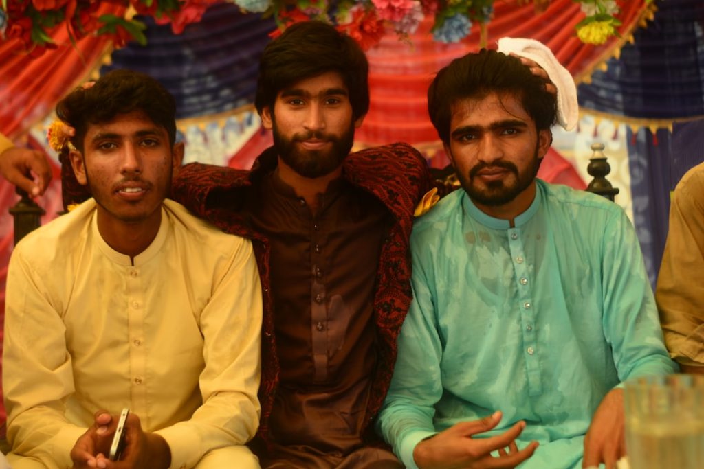 Pakistani young men in shalwar kameez at a family gathering event in Punjab