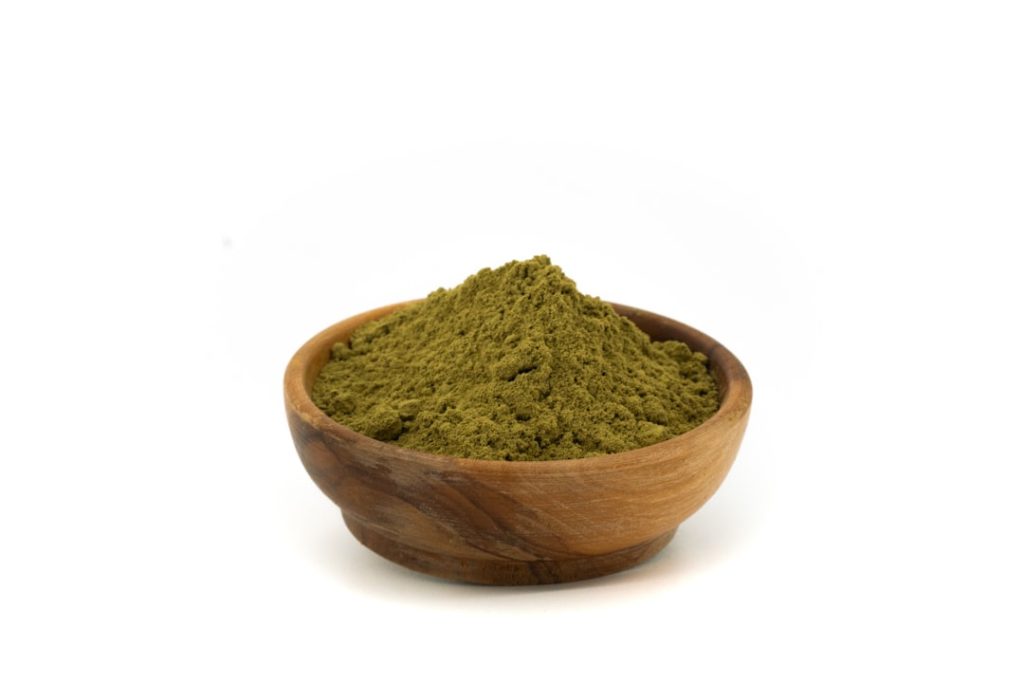 Mehndi powder wooden bowl — henna powder for natural hair darkening